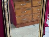 un miroir posé sur une table devant une commode