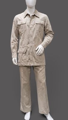 mannequin dressed in khaki suit and hat on a gray background