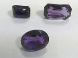 three amethtites of different shapes and sizes