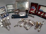 a table with silverware and other silverware on it