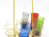 four glasses in a basket on a white surface
