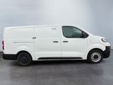 the white van is parked on the concrete floor in the room