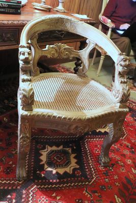 a man sitting at a desk with a chair in front of him