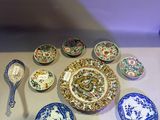 many plates and spoons that are on the table