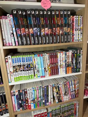 a book shelf full of dvds and dvds in a room