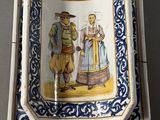 a blue and white plate with a picture of a man and a woman on it