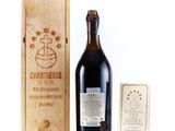 a bottle of wine in front of a wooden box