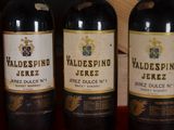 several bottles of wine are lined up on a table