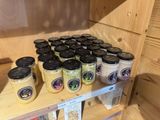 many jars of food sitting on a shelf in a store