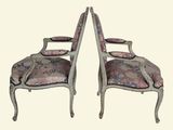 pair of antique chairs with floral upholstered upholstered cushions