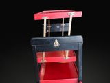 a small red and black table with a black top