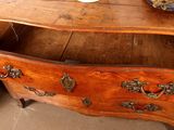 a wooden desk with a bowl of flowers on top of it