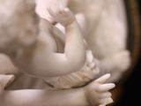 a statue of a baby in a bowl on a table