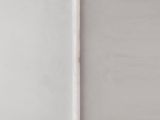 a close up of a toothbrush sitting on top of a white surface