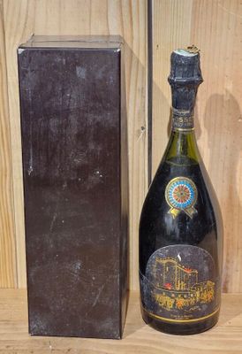 a bottle of wine sitting next to a box on a shelf
