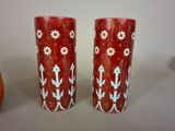 two red vases sitting next to each other on a table
