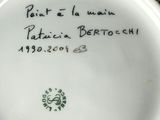 the bottom of a white plate with writing on it