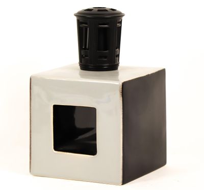 une tasse noire et blanche posée sur une boîte blanche