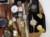 a lot of watches on a wooden tray on a table