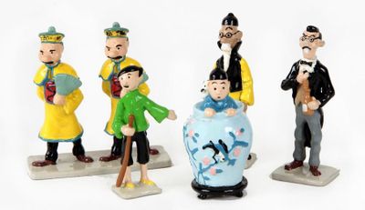 four figurines of different people standing next to each other