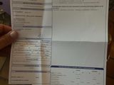 a person that is holding a receipt in their hand
