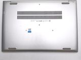 a close up of a silver laptop with a blue sticker on it