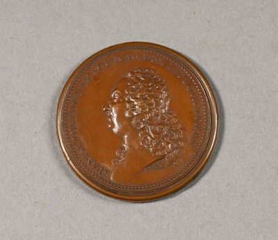 l'image d'une pièce de monnaie sur laquelle figure une tête de femme