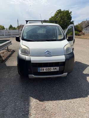 a small white van parked on the side of the road