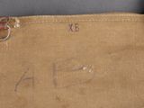 a close up of a tan canvas bag with writing on it