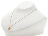 a white mannequin with a gold necklace on it