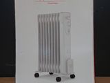 packaging of a white electric radiator sitting on top of a wooden table