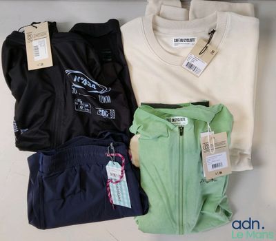 Trois paires de vêtements pour homme sont exposées dans un magasin.