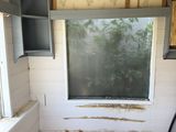 a window in the corner of a room that is being remodeled