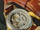 a watch that is sitting on a glass table