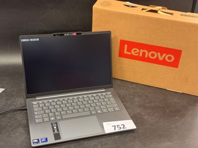 lenovo laptop with box and charger on table next to it