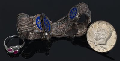 two rings and a dime are sitting next to each other on a table
