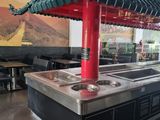 a picture of a restaurant with a long counter and a red roof