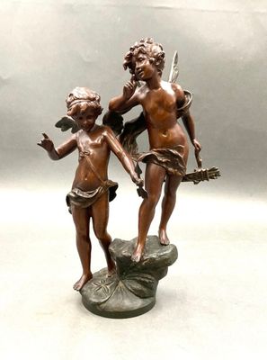 bronze statue of a boy and a girl on a rock