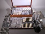 a wooden case with silverware in it on a table