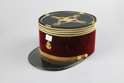 a red hat with gold trim and a skull and crossbone on it