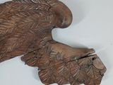 wooden carving of a bird with a long beak on a white surface
