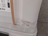 a large white box with a brown handle on the floor