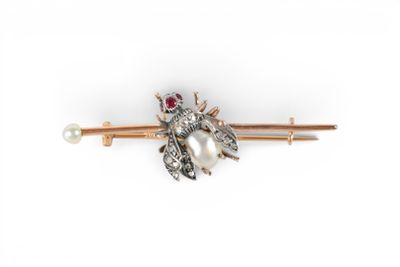 an image of a brooch with a pearl and a bee on it