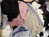 a pile of clothes that is sitting on the floor