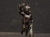 bronze figurine of a man with a spear and arrow on a pedestal