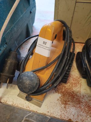 an image of a corded sander and other tools on a table