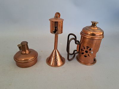 trois types différents de théières en cuivre posées sur une table