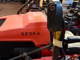 an image of a red lawn mower parked in a garage