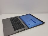 the laptop is open on a white surface with a blue screen