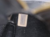 the inside of a black purse with a tag on it